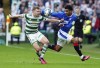 Celtic's Alistair Johnston, left, and Rangers' Malik Tillman battle for the ball during the Scottish Premiership soccer match at Celtic Park, Glasgow, Scotland, Saturday April 8, 2023. (Jane Barlow/PA via AP)