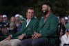Scottie Scheffler sits with Jon Rahm, of Spain, after Rahm won the Masters golf tournament at Augusta National Golf Club on Sunday, April 9, 2023, in Augusta, Ga.(AP Photo/Jae C. Hong)