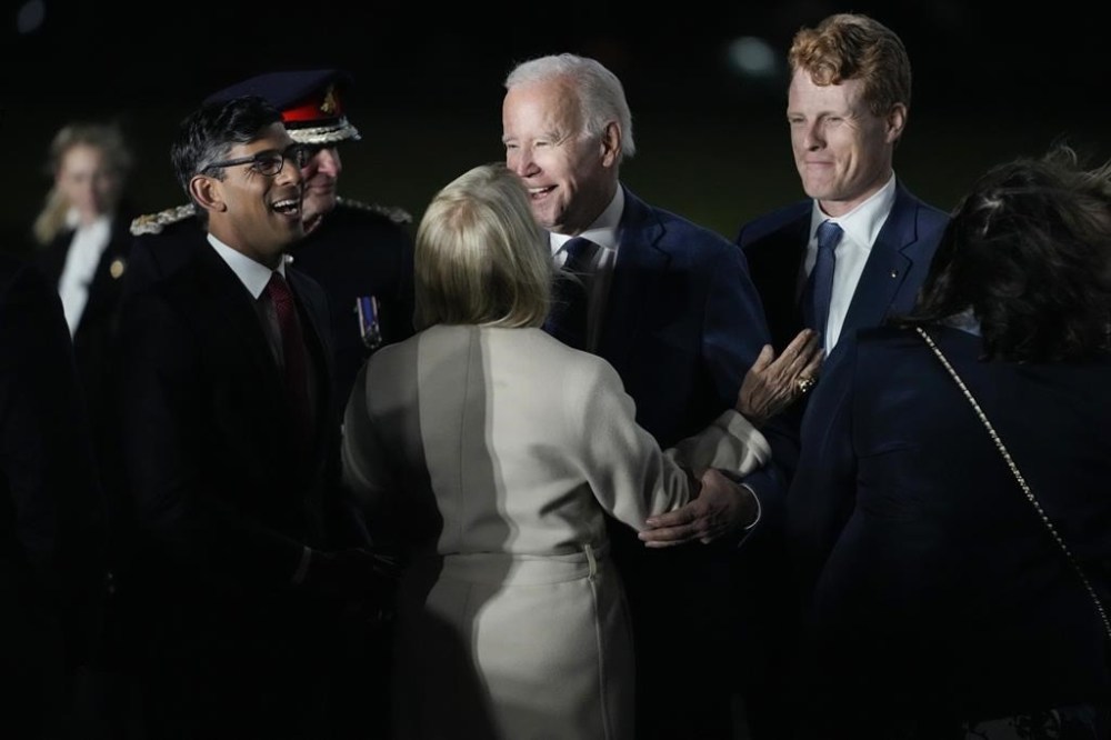 President Joe Biden is greeted by British Prime Minister Rishi Sunak, left, and US Ambassador to the United Kingdom Jane Hartley, center, he steps off Air Force One at Belfast International Airport in Belfast, Northern Ireland, Tuesday, April 11, 2023. Biden is visiting the United Kingdom and Ireland in part to help celebrate the 25th anniversary of the Good Friday Agreement. At right is United States Special Envoy for Northern Ireland Joe Kennedy III. (AP Photo/Patrick Semansky)