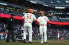 San Francisco Giants' LaMonte Wade Jr. (31) and Michael Conforto, right, celebrate after they scored against the Los Angeles Dodgers on Joc Pederson's double during the first inning of a baseball game in San Francisco, Tuesday, April 11, 2023. (AP Photo/Godofredo A. Vásquez)