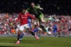 Everton's goalkeeper Jordan Pickford saves on an attempt to score by Manchester United's Marcus Rashford during the English Premier League soccer match between Manchester United and Everton, at the Old Trafford stadium in Manchester, England, Saturday, April 8, 2023. (AP Photo/Dave Thompson)