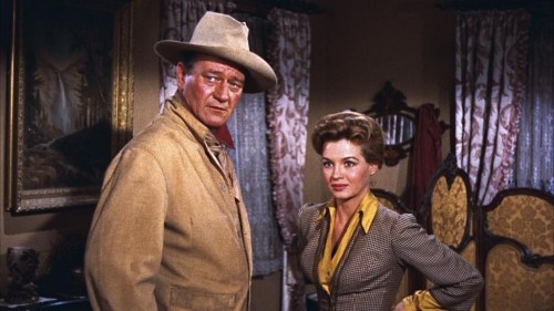 This image released by Warner Bros. Entertainment shows John Wayne as Sheriff John T. Chance, left, and Angie Dickinson as Feathers in a scene from 