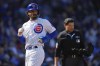 Chicago Cubs shortstop Dansby Swanson scores as Chicago Cubs Ian Happ grounds out softly to Texas Rangers first baseman Nathaniel Lowe during the first inning of a baseball game Saturday, April 8, 2023, in Chicago. (AP Photo/Erin Hooley)