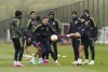 Manchester United's Diogo Dalot and Lisandro Martinez attend a training session at the AON Training Complex, Carrington, England, Wednesday April 12, 2023, a day ahead of the Europa League soccer match between Manchester United and Sevilla. (Nick Potts/PA via AP)