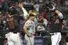 Arizona Diamondbacks' Lourdes Gurriel Jr. celebrates with Josh Rojas (10) after hitting a three run home run against the Milwaukee Brewers in the third inning during a baseball game, Wednesday, April 12, 2023, in Phoenix. (AP Photo/Rick Scuteri)