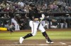 Arizona Diamondbacks' Christian Walker hits an RBI ground out against the Milwaukee Brewers in the first inning during a baseball game, Wednesday, April 12, 2023, in Phoenix. (AP Photo/Rick Scuteri)