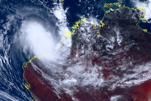 This satellite image taken by Himawari-8, a Japanese weather satellite, and provided by National Institute of Information and Communications Technology, shows cyclone Ilsa approaching Australia's west coast, Thursday, April 13, 2023. A severe tropical cyclone lashed the northwest Australian coast with strengthening winds and increasing rain Thursday as authorities warned the population to prepare for destructive gusts of up to 275 kph (171 mph). (Courtesy of National Institute of Information and Communications Technology (NICT) via AP)
