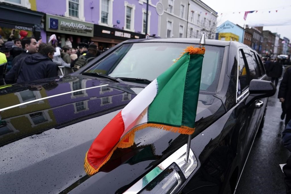 The flag of Ireland is seen on President Joe Biden's motorcade as he tours Dundalk, Ireland, Wednesday, April 12, 2023. (AP Photo/Patrick Semansky)