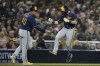 Milwaukee Brewers' Mike Brosseau, right, celebrates with third base coach Jason Lane after hitting a home run during the fifth inning of a baseball game against the San Diego Padres, Thursday, April 13, 2023, in San Diego. (AP Photo/Gregory Bull)