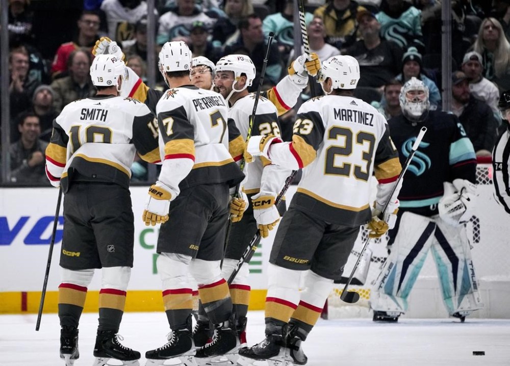 Vegas Golden Knights right wing Reilly Smith, left, celebrates a goal against the Seattle Kraken with teammates, including Alex Pietrangelo (7), Michael Amadio (22) and Alec Martinez (23), during the first period of an NHL hockey game Thursday, April 13, 2023, in Seattle. (AP Photo/Lindsey Wasson)