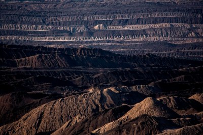 FILE - Mining debris covers the ground of a lignite coal pit near the village of Welzow in the Lusatia (Lausitz) area in Germany, June 5, 2018. Germany is shutting down its last three nuclear power plants on Saturday, April 15, 2023, as part of an energy transition agreed by successive governments. Critics have warned that without nuclear power, Germany will have to rely on dirty coal and gas plants for energy during periods of overcast but calm weather. (AP Photo/Markus Schreiber, File)