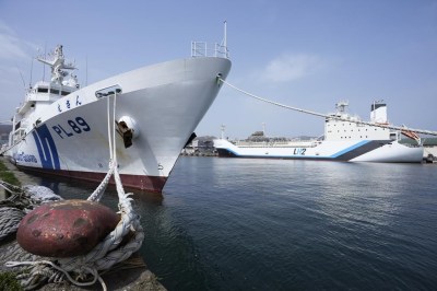 The Suiso Frontier, back right, a liquefied hydrogen carrier, is berthed as a Japan Coast Guard ship is docked to watch the area in Otaru, northern Japan, Friday, April 14, 2023. U.S. Energy Secretary Jennifer Granholm took a tour Friday on the liquefied hydrogen carrier, the day before the G-7 ministers' meeting on climate, energy and environment. (AP Photo/Hiro Komae)