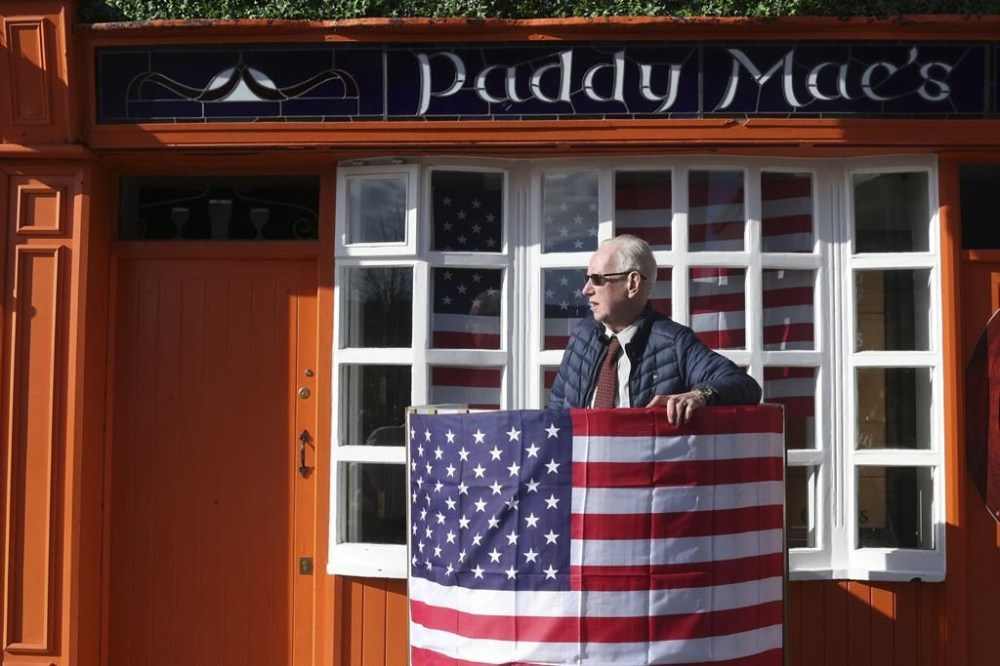 Last minute preparation are made with bunting and US flags put up in the town of Ballina ahead of the visit by President Joe Biden to St Muredach's Cathedral, in Ballina, Ireland, Friday, April 14, 2023. The President will give a speech later Friday outside the cathedral. (AP Photo/Peter Morrison)