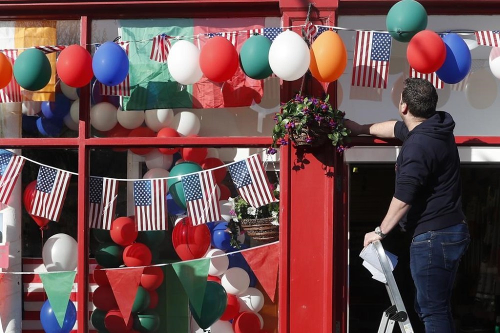 Last minute preparation are made with bunting and US flags put up in the town of Ballina ahead of the visit by President Joe Biden to St Muredach's Cathedral, in Ballina, Ireland, Friday, April 14, 2023. The President will give a speech later Friday outside the cathedral. (AP Photo/Peter Morrison)