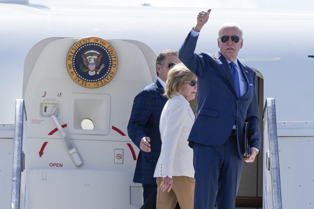 President Joe Biden boards Air Force One at Dublin International Airport in Dublin, Friday, April 14, 2023. Biden is en route to County Mayo, Ireland. At left is his sister Valerie Biden Owens and his son Hunter Biden. (AP Photo/Patrick Semansky)