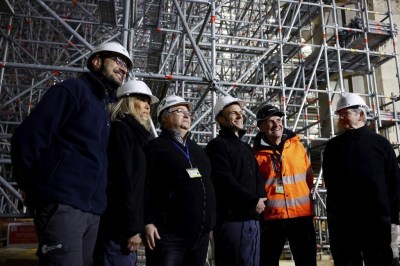 French President Emmanuel Macron, third right, and his wife Brigitte Macron, second left, visit the restoration site at the Notre-Dame de Paris Cathedral, which was damaged in a devastating fire four years ago, Friday, April 14, 2023 in Paris. (Sarah Meyssonnier/Pool via AP)