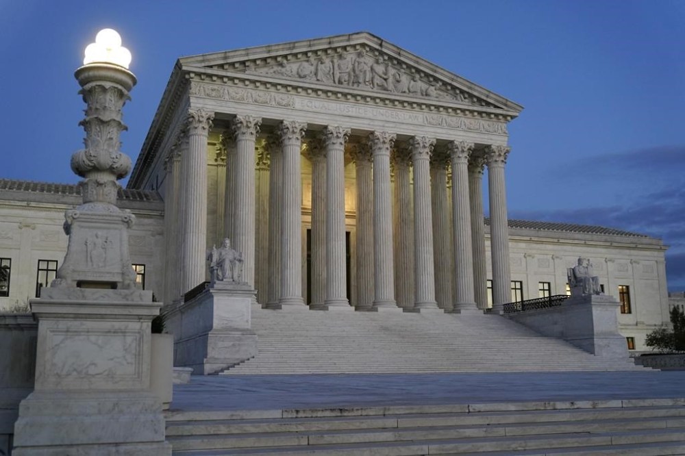 FILE - Light illuminates part of the Supreme Court building at dusk on Capitol Hill in Washington, Nov. 16, 2022. The Supreme Court is allowing challenges to the structure of two federal agencies to go forward in federal court. The high court ruled unanimously Friday, April 14, 2023, to allow challenges to the structure of both the Federal Trade Commission and the Securities and Exchange Commission to go forward in federal court. (AP Photo/Patrick Semansky, File)