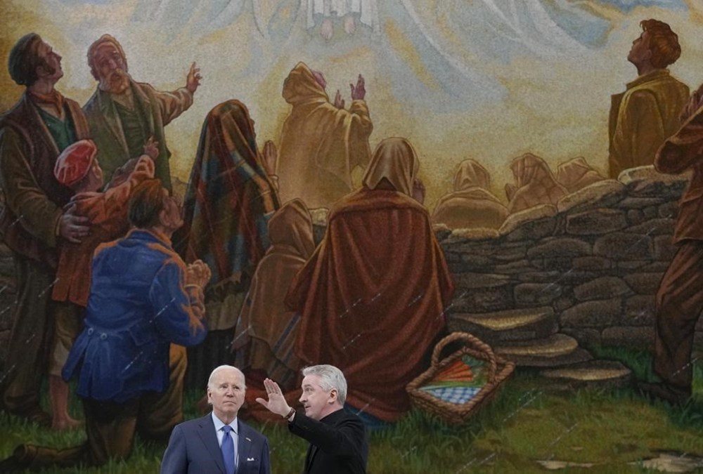 President Joe Biden tours the Knock Shrine with Father Richard Gibbons, parish priest and rector of Knock Shrine, in Knock, Ireland, Friday, April 14, 2023. (AP Photo/Patrick Semansky)