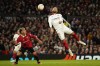 Manchester United's Lisandro Martinez, left, watches as Sevilla's Nemanja Gudelj aims for the ball during the Europa League first leg quarterfinal soccer match between Manchester United and Sevilla at the Old Trafford stadium in Manchester, Thursday, April 13, 2023. (AP Photo/Dave Thompson)