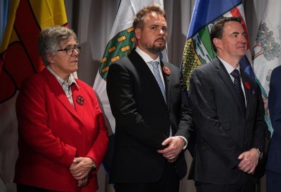 Northwest Territories Minister of Health and Social Services Julie Green, from left to right, Alberta Minister of Mental Health and Addiction Nicholas Milliken and Alberta Health Minister Jason Copping listen during a news conference, in Vancouver, on Tuesday, Nov. 8, 2022. The Alberta government says it will fund mental health and addiction supports for people being held in police custody in Calgary and expand community-led harm reduction teams in the city. THE CANADIAN PRESS/Darryl Dyck