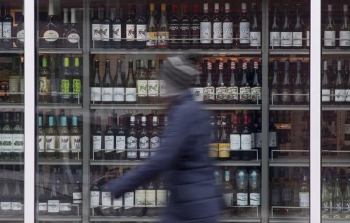A person walks past shelves of bottles of alcohol on display at an LCBO in Ottawa, Thursday March 19, 2020. Researchers behind the latest guidance on drinking alcohol are calling on Health Canada to update its website with their findings to avoid confusion about safe levels of consumption.THE CANADIAN PRESS/Adrian Wyld