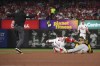 Pittsburgh Pirates' Canaan Smith-Njigba (28) safely steals second base in the fourth inning against St. Louis Cardinals' Brendan Donovan (33) during a baseball game Friday, April 14, 2023, in St. Louis. (AP Photo/Michael Thomas)