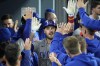 Chicago Cubs' Patrick Wisdom is congratulated by teammates in the dugout after hitting a solo home run during the eighth inning of a baseball game against the Los Angeles Dodgers Friday, April 14, 2023, in Los Angeles. (AP Photo/Mark J. Terrill)