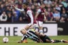 Aston Villa's Douglas Luiz, top, controls the ball from Newcastle United's Bruno Guimaraes during the English Premier League soccer match between Newcastle and Aston Villa, at Villa Park, Birmingham, England, Saturday April 15, 2023. (Jacob King/PA via AP)