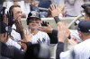 New York Yankees' Anthony Rizzo is greeted in the dugout after hitting a solo home run in the third inning of a baseball game against the Minnesota Twins, Saturday, April 15, 2023, in New York. (AP Photo/Mary Altaffer)
