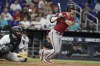 Arizona Diamondbacks' Josh Rojas, right, follows through to reach second on a throwing error by Miami Marlins starting pitcher Sandy Alcantara (not shown) during the sixth inning of a baseball game, Sunday, April 16, 2023, in Miami. Marlins catcher Jacob Stallings, left, looks on. (AP Photo/Lynne Sladky)