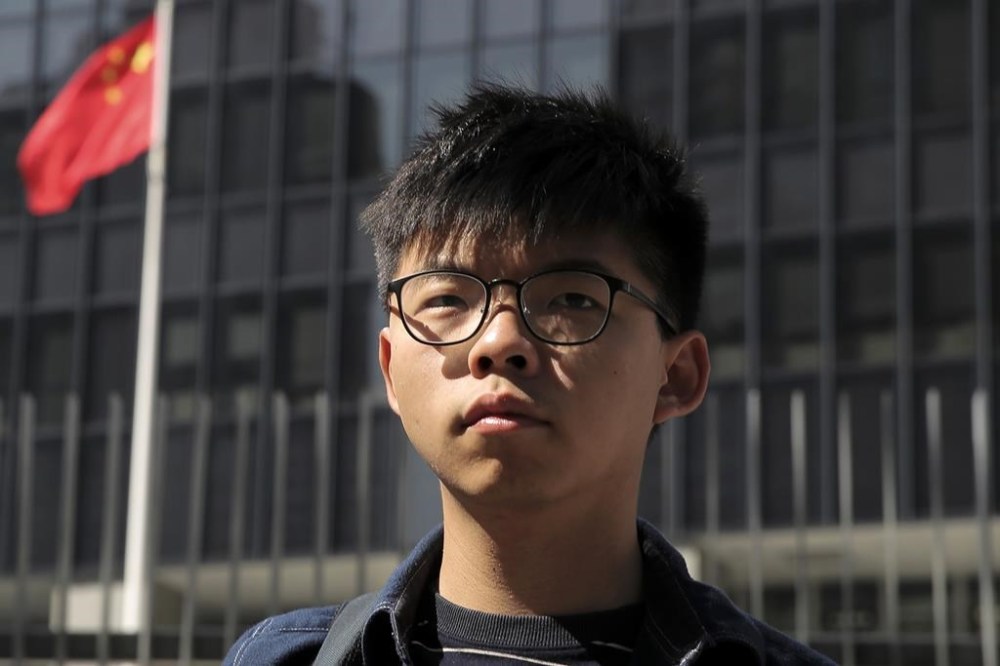 FILE - Pro-democracy activist Joshua Wong stands outside the Legislative Council building in Hong Kong on Nov. 28, 2019. Wong was sentenced Monday, April 17, 2023 to three months in prison for breaching court bans on disclosing personal information about a police officer during 2019 anti-government protests. (AP Photo/Kin Cheung, File)