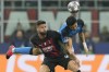 AC Milan's Olivier Giroud, left, is challenged by Napoli's Kim Min-jae during the Champions League quarterfinal, first leg, soccer match between AC Milan and Napoli, at the San Siro stadium in Milan , Italy, Wednesday, April 12, 2023. (AP Photo/Antonio Calanni)