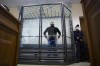 FILE - Andrei Pivovarov, former head of Open Russia movement stands behind the glass during a court session in Krasnodar, Russia, on June 2, 2021. Just days after the Open Russia opposition group that he headed disbanded in 2021 when authorities declared it an 