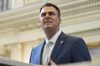 FILE - Oklahoma Gov. Kevin Stitt delivers his State of the State address on Feb. 6, 2023, in Oklahoma City. Stitt called for the resignations of several county officials on Sunday, April 16, in far southeast Oklahoma after the local newspaper released an audio recording of some of them discussing killing local journalists and hanging Black people. (AP Photo/Sue Ogrocki, File)