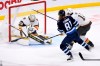 Vegas Golden Knights goaltender Adin Hill (33) makes a save on Winnipeg Jets’ Kyle Connor (81) during third period NHL action in Winnipeg on Tuesday December 13, 2022. THE CANADIAN PRESS/Fred Greenslade