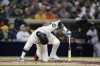 San Diego Padres' Manny Machado falls as he flies out during the sixth inning of a baseball game against the Atlanta Braves, Monday, April 17, 2023, in San Diego. (AP Photo/Gregory Bull)