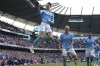 Manchester City's John Stones, center, celebrates after scoring his side's opening goal during the English Premier League soccer match between Manchester City and Leicester City at Etihad Stadium in Manchester, England, Saturday, April 15, 2023. (Nick Potts/PA via AP)