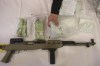 An OPP officer picks up a bag containing fentanyl as it lies next to cash and a firearm on a display table as Ontario Provincial Police host a news conference in Vaughan, Ont., on Thursday, February 23, 2017. Senior members of President Joe Biden's cabinet will be in Ottawa in the coming weeks to meet with their Canadian counterparts about cracking down on fentanyl. THE CANADIAN PRESS/Chris Young