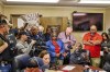 In this photo provided by the Southwest Ledger, Idabel Mayor Crain Young, seated right, at table with hands up, speaks at the McCurtain County Commissioners meeting in Idabel, Okla., Monday, April 17, 2023. Residents are calling for the resignation of several McCurtain County officials after tapes with the officials' racist comments surfaced over the weekend. (Christopher Bryan/Southwest Ledger via AP)