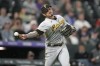 Pittsburgh Pirates starting pitcher Vince Velasquez throws to first base to put out Colorado Rockies' Yonathan Daza in the sixth inning of a baseball game Tuesday, April 18, 2023, in Denver. (AP Photo/David Zalubowski)