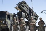 FILE - Members of US 10th Army Air and Missile Defense Command stands next to a Patriot surface-to-air missile battery during the NATO multinational ground based air defence units exercise 