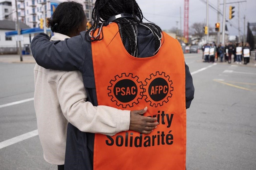 PSAC workers and supporters walk a picket line in Halifax on Wednesday, April 19, 2023. Federal departments and agencies have released a list of services that may be disrupted now that workers are on strike. THE CANADIAN PRESS/Darren Calabrese