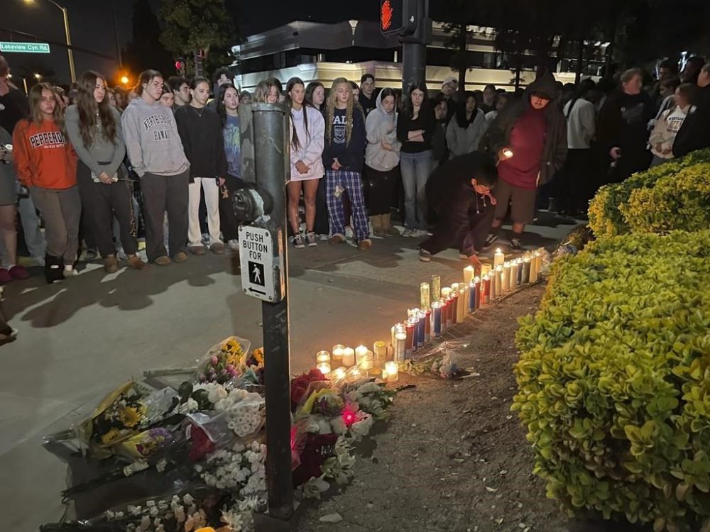 Mourners light candles outside Westlake High School in Thousand Oaks, Calif., Tuesday night, April 18, 2023. One teenager was killed and three others injured Tuesday afternoon when a stabbing suspect crashed a vehicle into a group as they were walking near their high school, authorities said. (Joe Curley/Ventura County Star via AP)