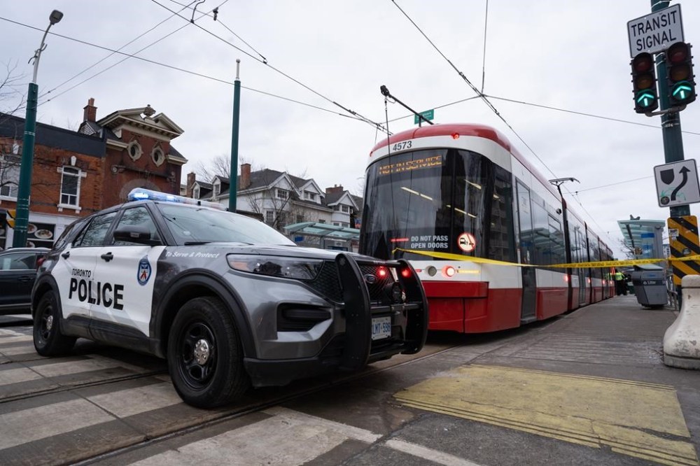 Police cars surround a TTC streetcar on Spadina Ave., in Toronto on Tuesday, January 24, 2023 after a stabbing incident. As Canadian cities look for ways to combat violence on public transit, experts say strategies south of the border that combine law enforcement, social supports and community engagement could offer new solutions to the issue. THE CANADIAN PRESS/Arlyn McAdorey