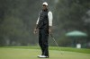 Tiger Woods reacts after missing a putt on the 18th hole during the weather delayed second round of the Masters golf tournament at Augusta National Golf Club on Saturday, April 8, 2023, in Augusta, Ga. (AP Photo/Charlie Riedel)
