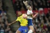 England's Leah Williamson vies for the ball with Brazil's Geyse, left, during the Women's Finalissima soccer match between England and Brazil at Wembley stadium in London, Thursday, April 6, 2023. (AP Photo/Kirsty Wigglesworth)