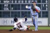 Toronto Blue Jays second baseman Whit Merrifield turns a double play over Houston Astros second baseman Mauricio Dubon (14) during the sixth inning of a baseball game Wednesday, April 19, 2023, in Houston. Alex Bregman was out at first. (AP Photo/Michael Wyke)