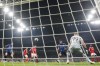 Inter Milan's Lautaro Martinez, center, shoots the ball to score his side's second goal during the Champions League quarterfinal second leg soccer match between Inter Milan and Benfica at the San Siro stadium in Milan, Italy, Wednesday, April 19, 2023. Inter Milan won 5-3 on aggregate. (AP Photo/Luca Bruno)