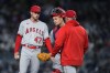 Los Angeles Angels starting pitcher Griffin Canning, left, waits with catcher Matt Thaiss as manager Phil Nevin comes to remove Canning during the sixth inning of the team's baseball game against the New York Yankees on Wednesday, April 19, 2023, in New York. (AP Photo/Frank Franklin II)