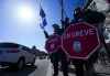 PSAC workers and supporters gather on a picket line in Ottawa on Thursday, April 20, 2023. A First Nation in southern Ontario says five federally run schools in its community are closed today as a result of a strike by federal public service workers. THE CANADIAN PRESS/Sean Kilpatrick